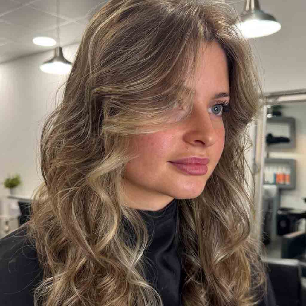 Modern layered haircut by Alina Kalinichenko — soft volume and movement for a natural everyday look.