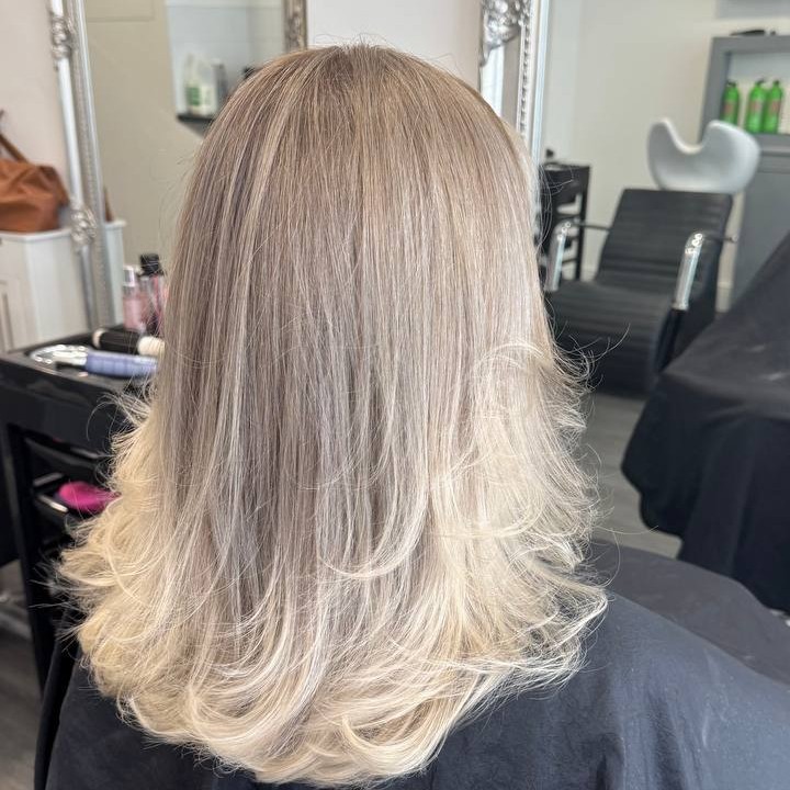 Back view of cool blonde highlights with blended transitions created in Ryde